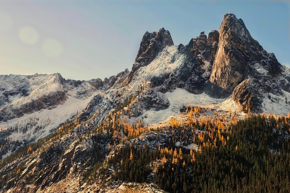 Autumn sunrise at North Cascades. Golden Larches on Early Winter Spires. Winthrop. Washington. United States.