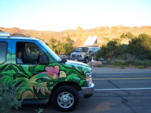 Two Escape Mavericks Campervans Giving Friendly Hand Gestures