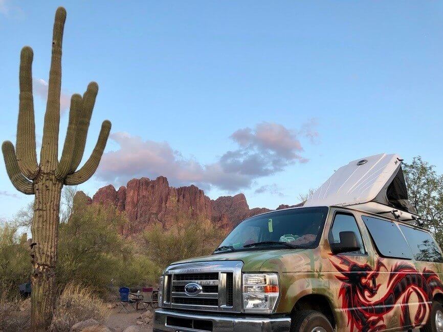 Campervan by a cactus in the desert