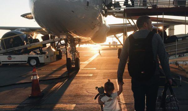 Walking to airplane father daughter