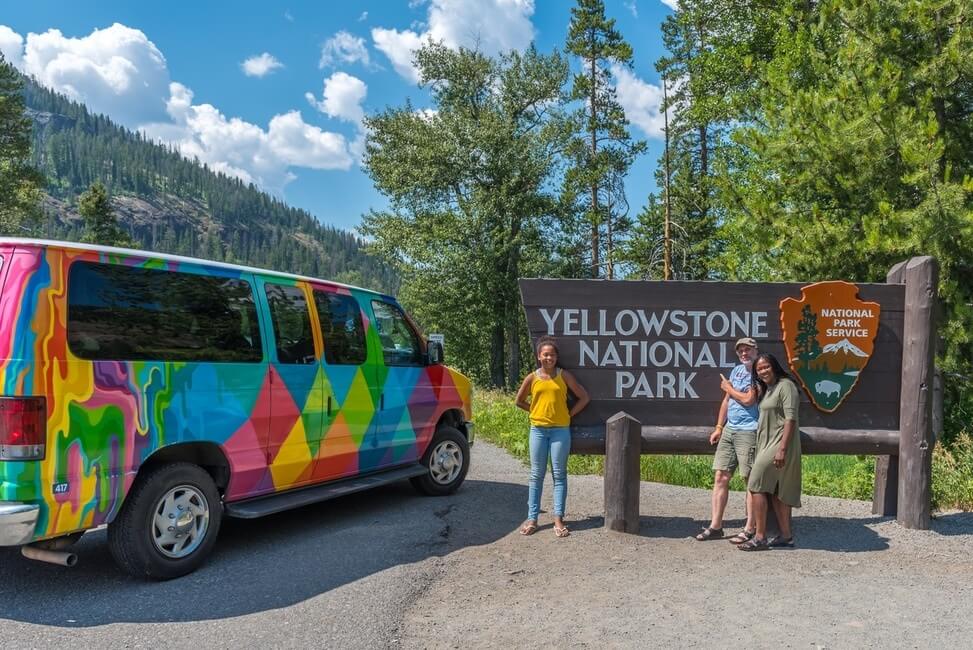 A family with their campervan at the entrance to Yellowstone National Park
