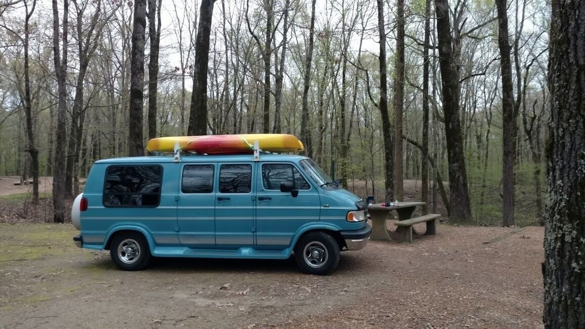 Blue campervan with kayak