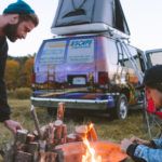 Cooking by Campfire Near Camper Van