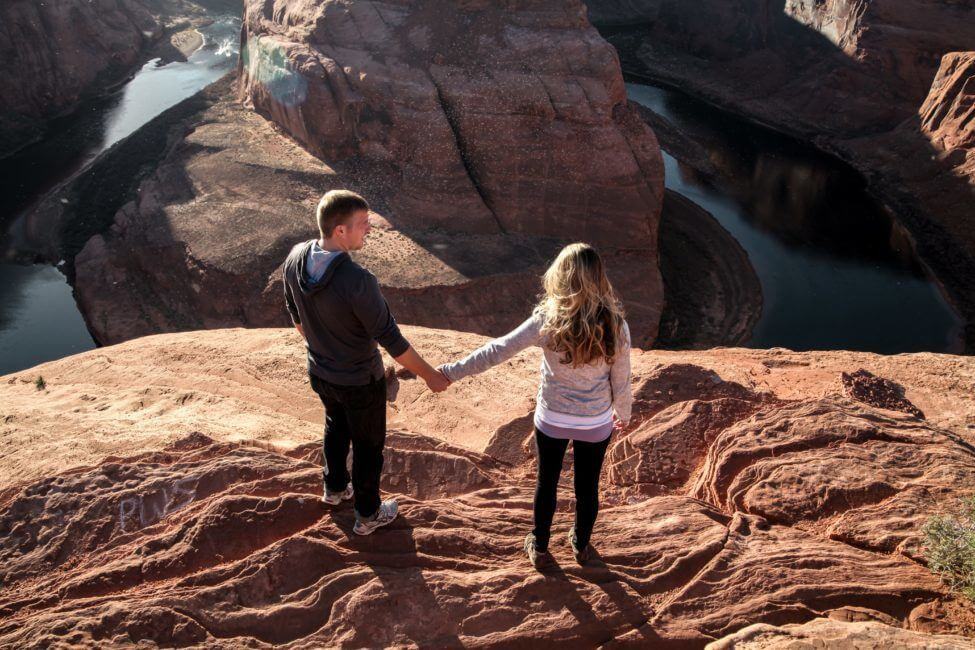 Couple holding hands at Horseshoe Bend Page Arizona
