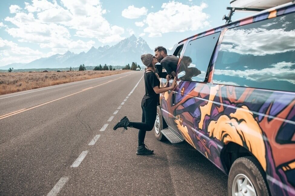 Couple on romantic road trip in campervan.