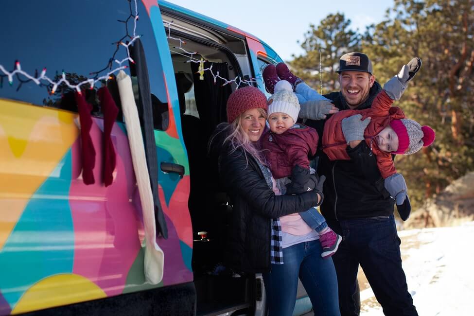 Family with campervan and Christmas lights