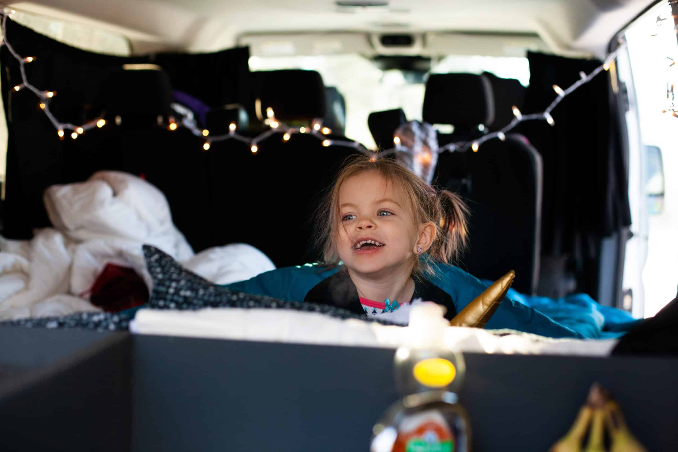Little girl sitting in a campervan.