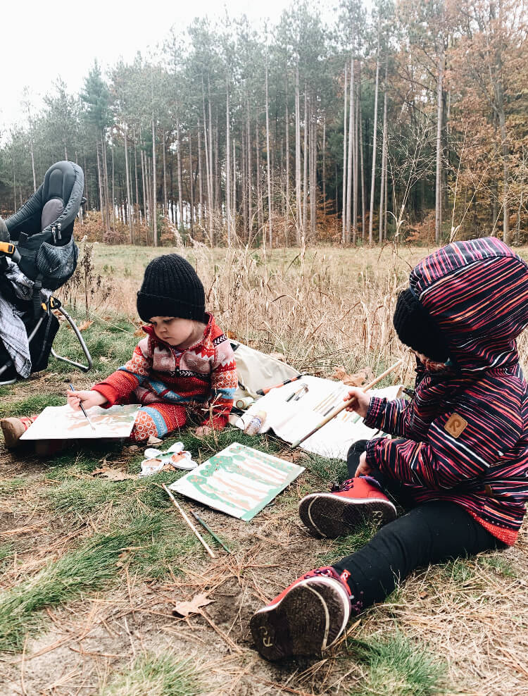 Kids painting outside.