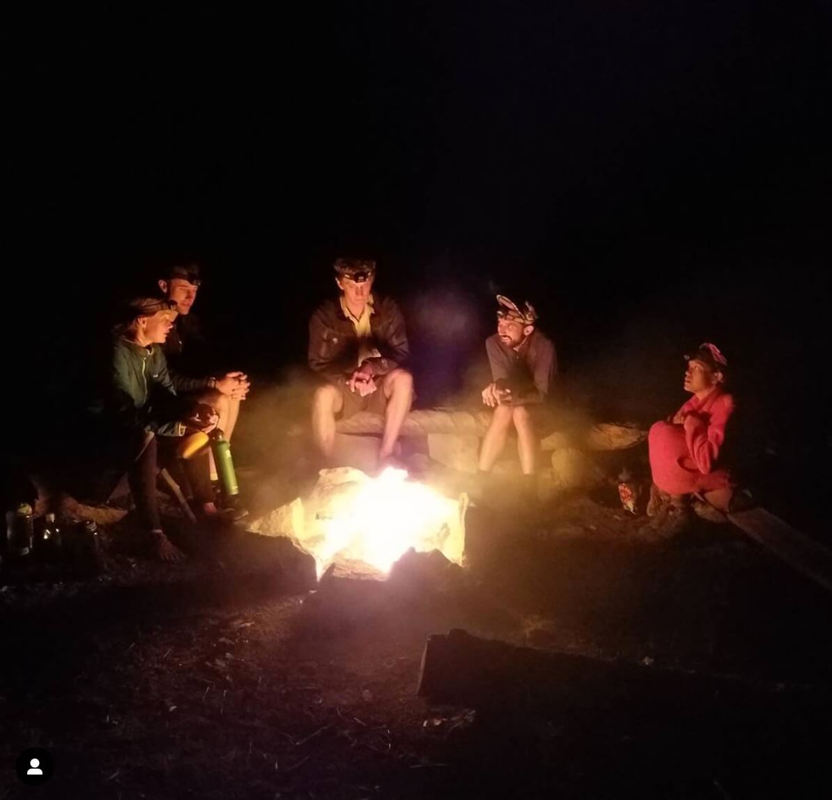 Campers gathering around the campfire