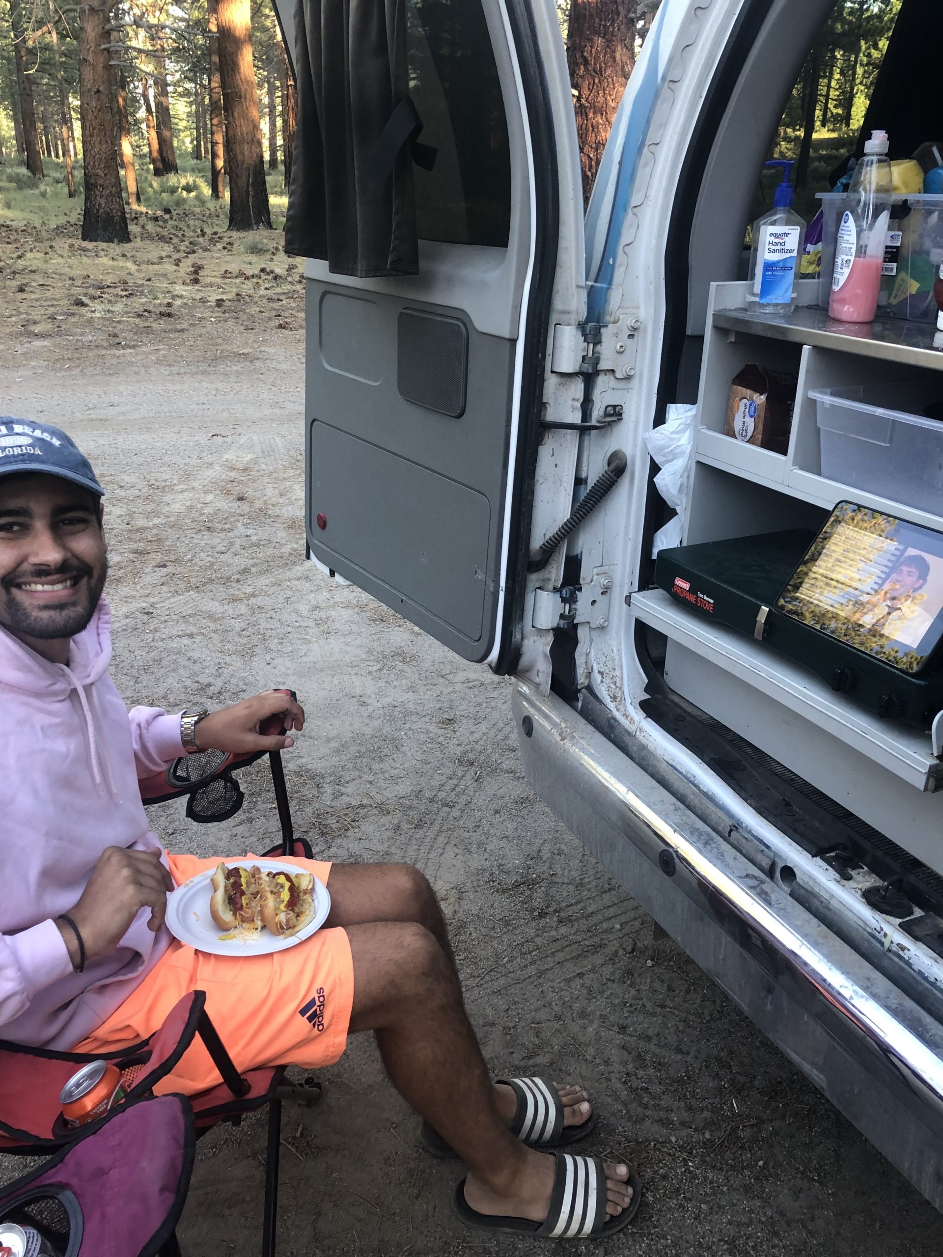 Man eating next to a campervan