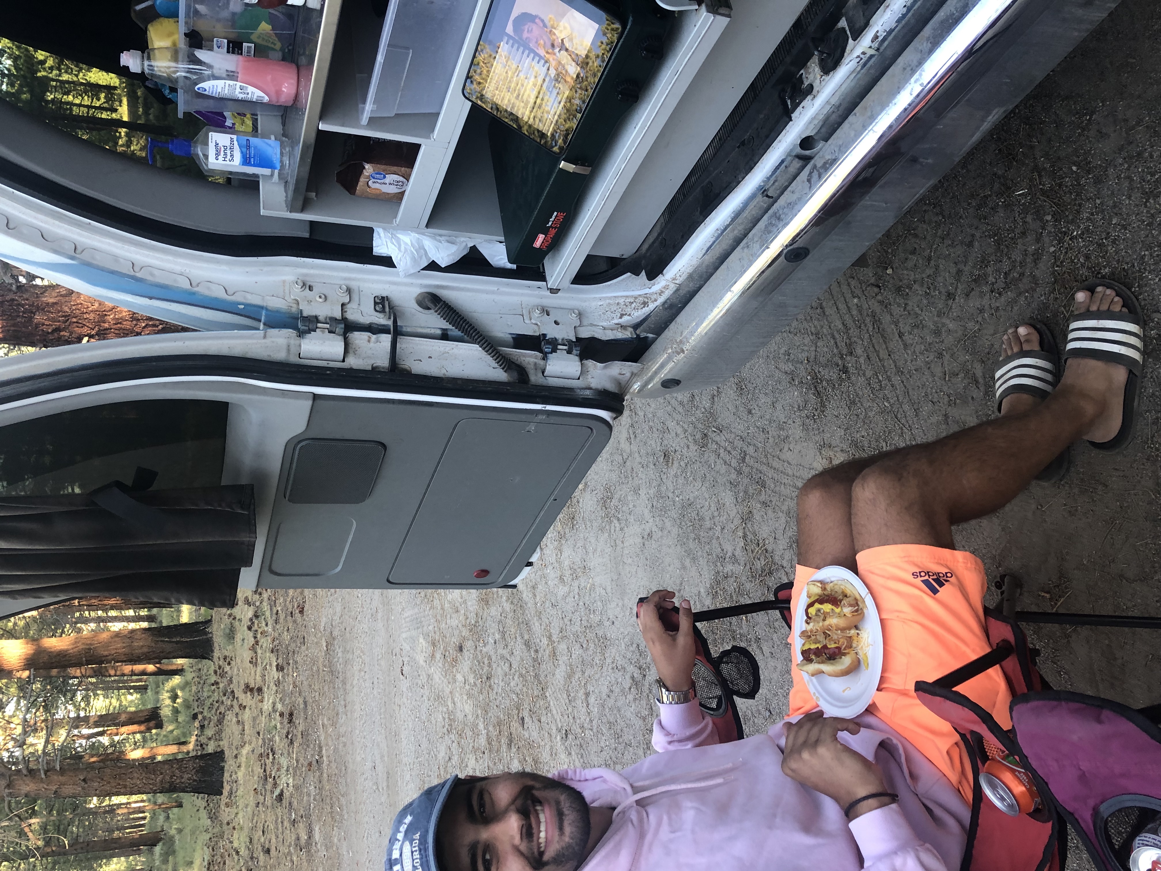 Man eating next to a campervan