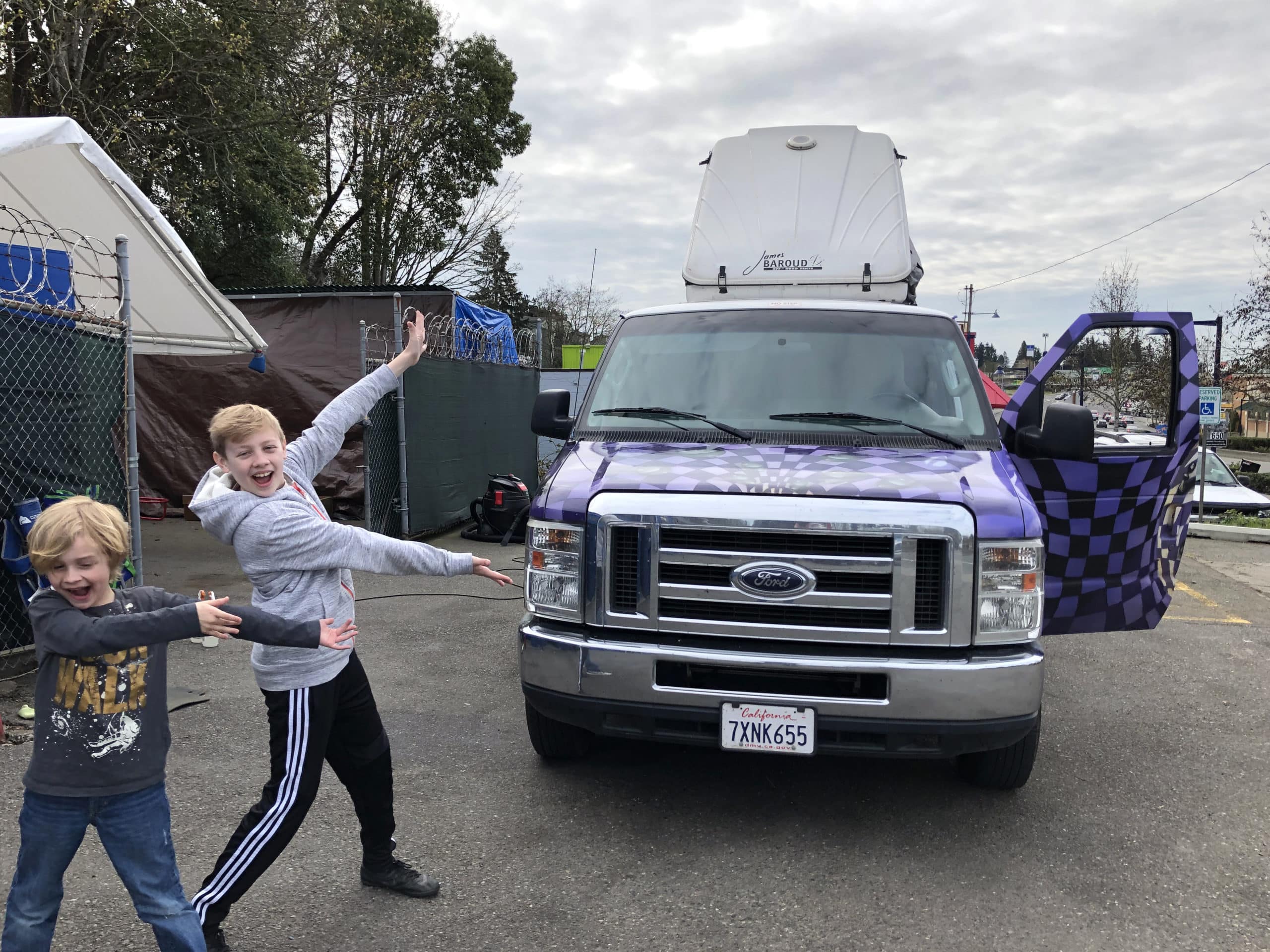 Two boys in front of an Escape Campervan