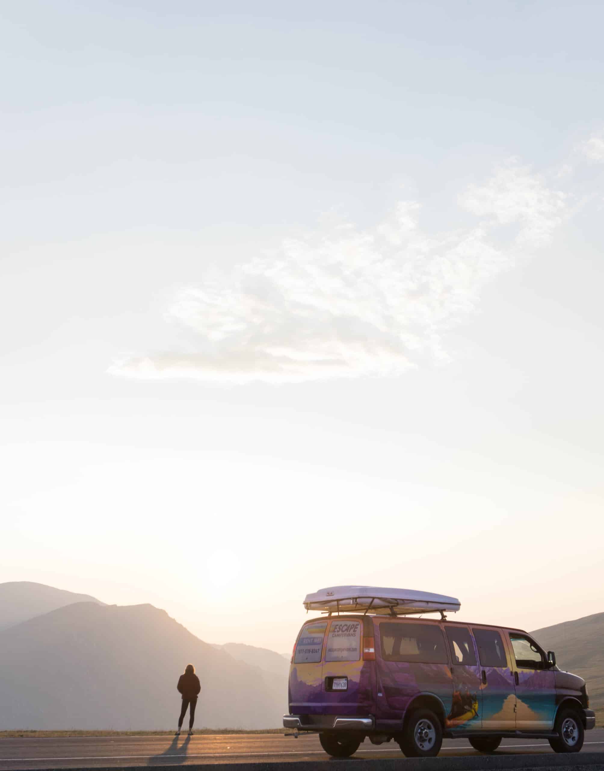 Camper van overlooking a valley on a Yellowstone camper van road trip.