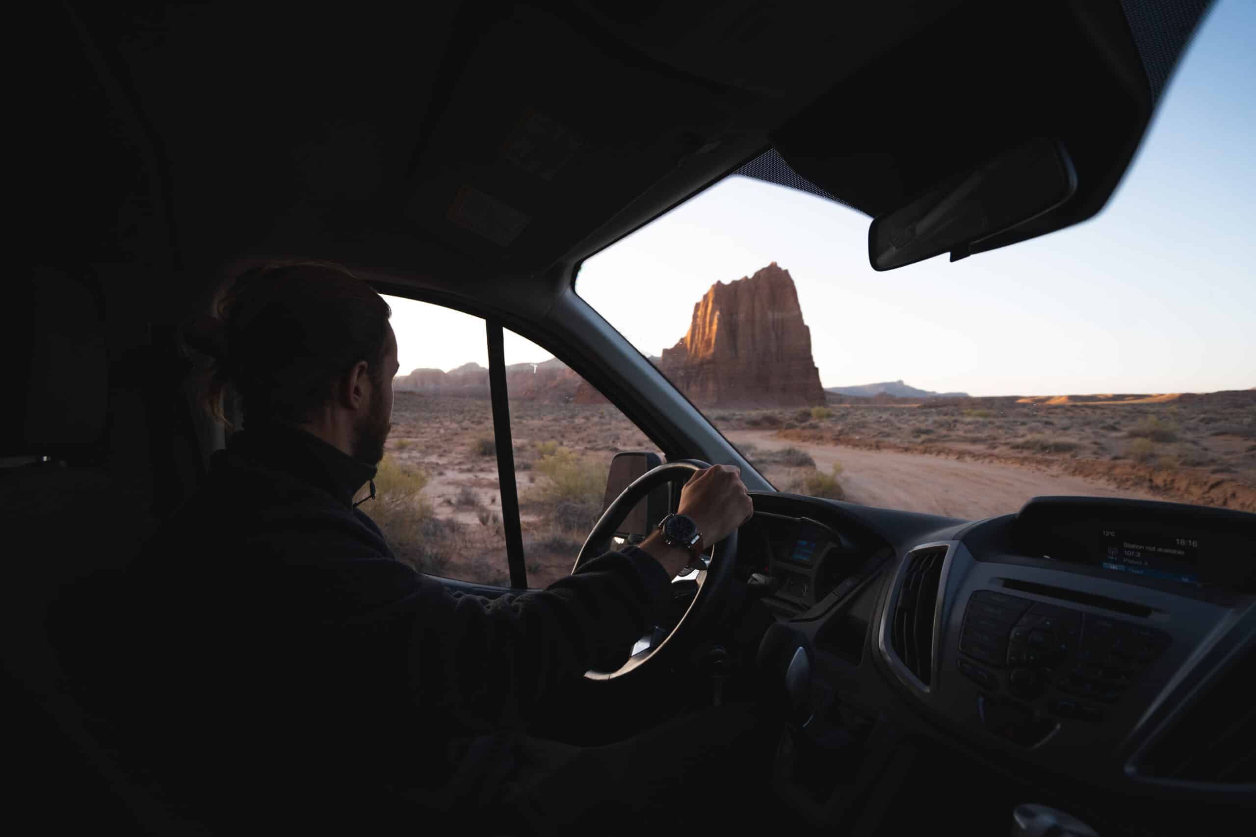 A person driving through Capitol Reef National Park in an Escape Camper Van.