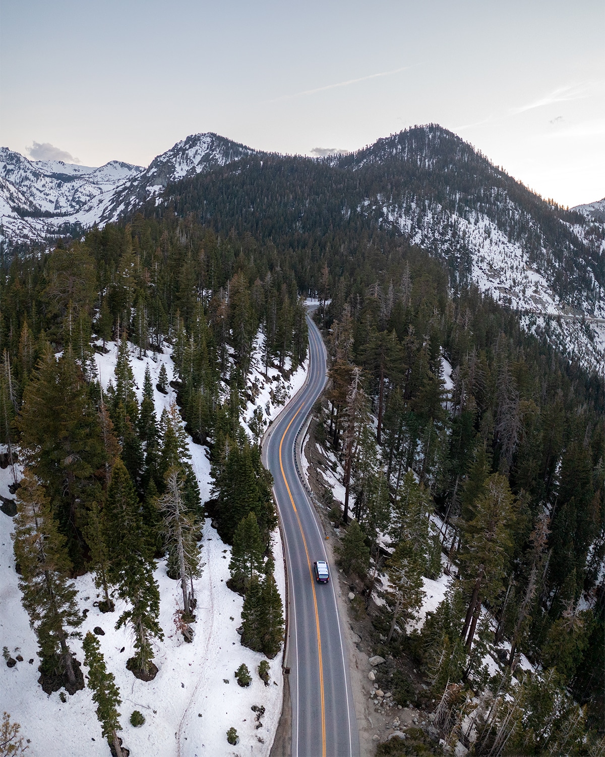 Escape Camper Van driving through Lake Tahoe on a road trip.