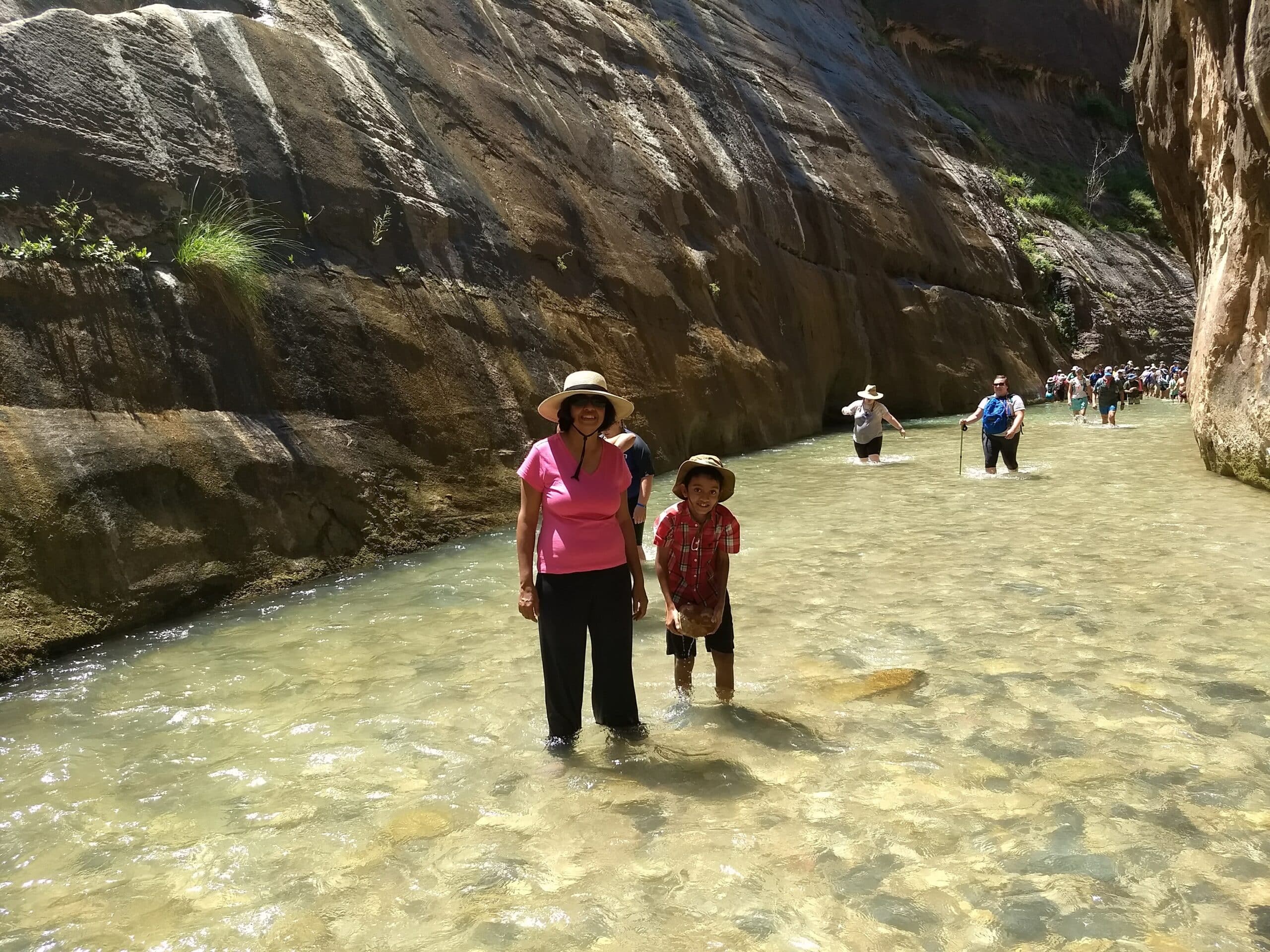 Two people standing in the Narrows in Zion National Park