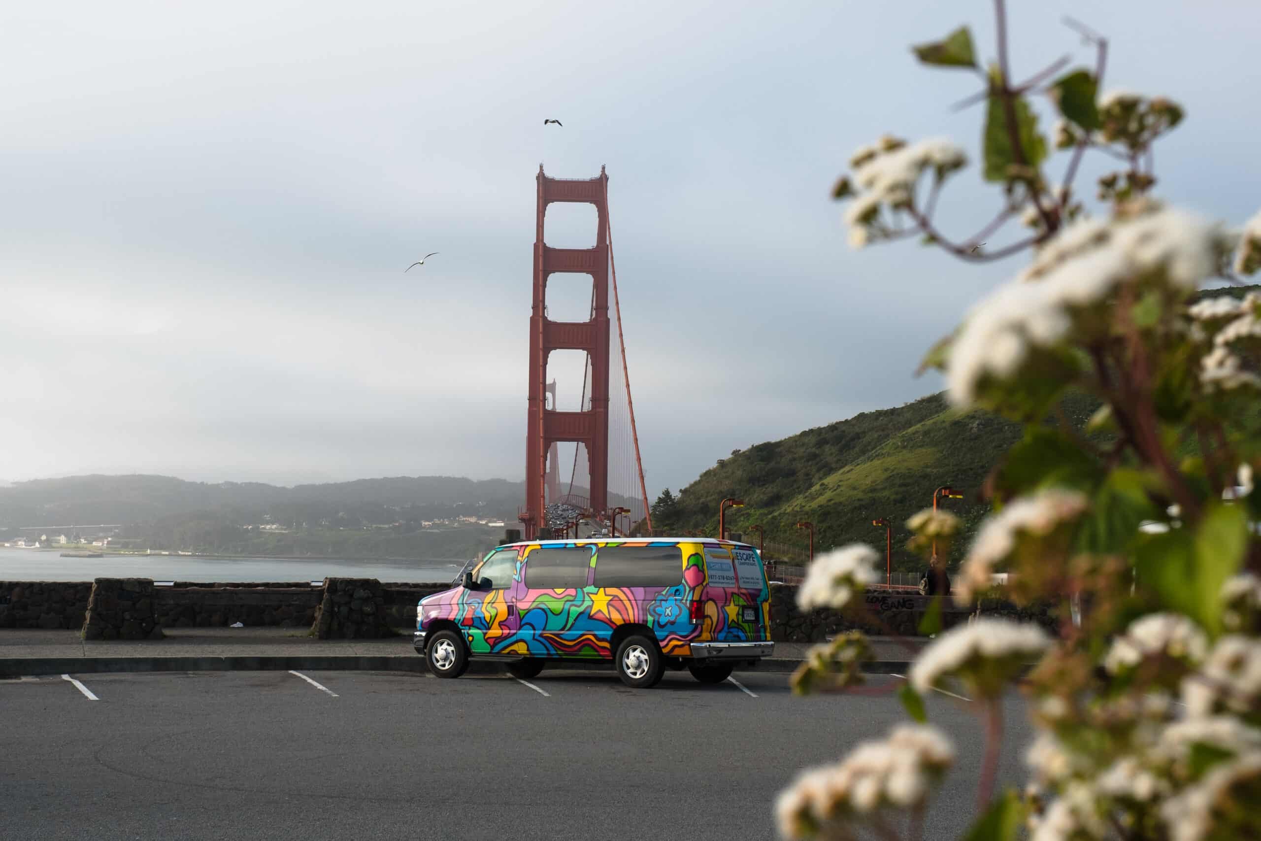 An Escape camper van parked in front of the Golden Gate Bridge.