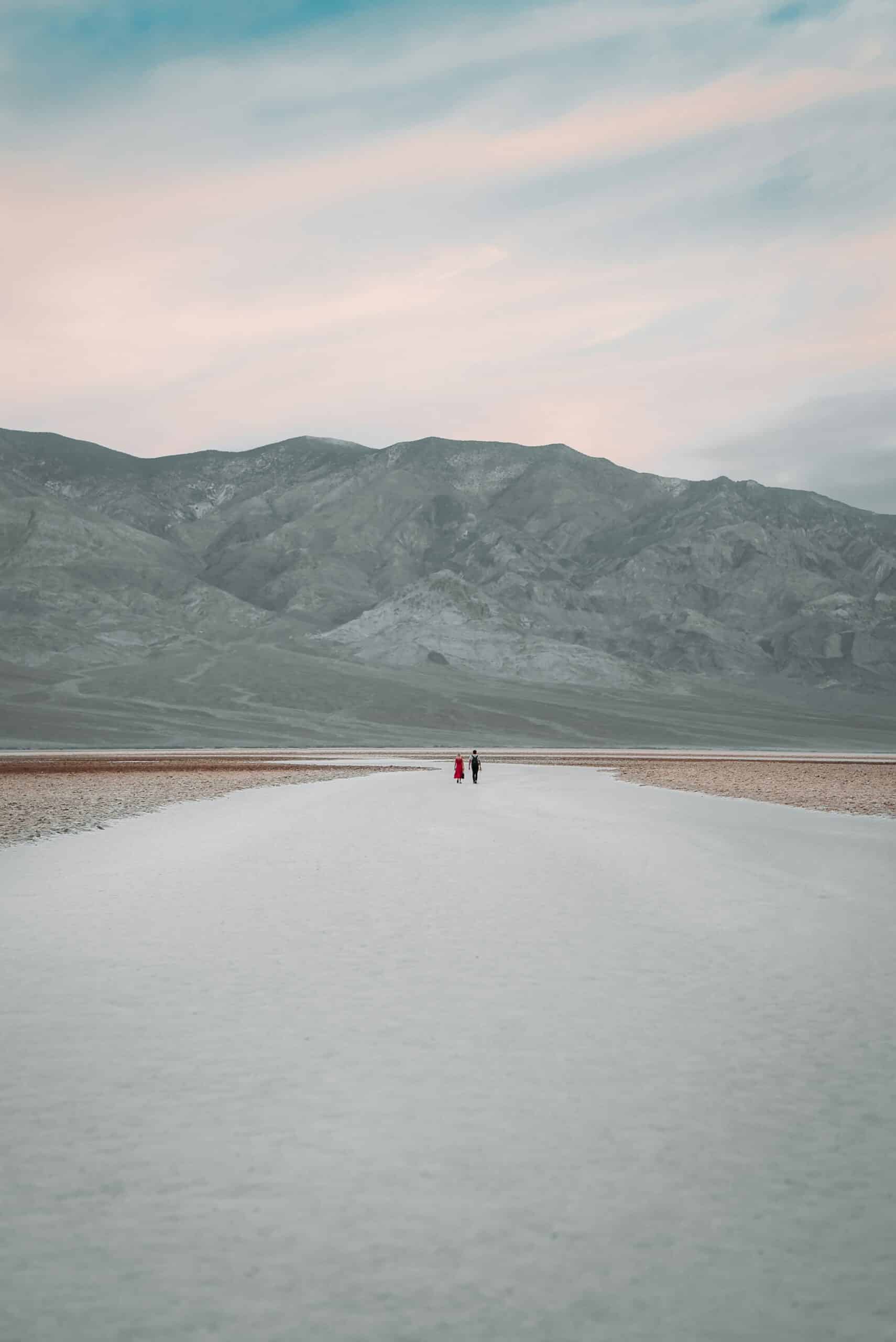 Two people standing on the Death Valley National Park lake. The lake is the result of heavy rains in California.