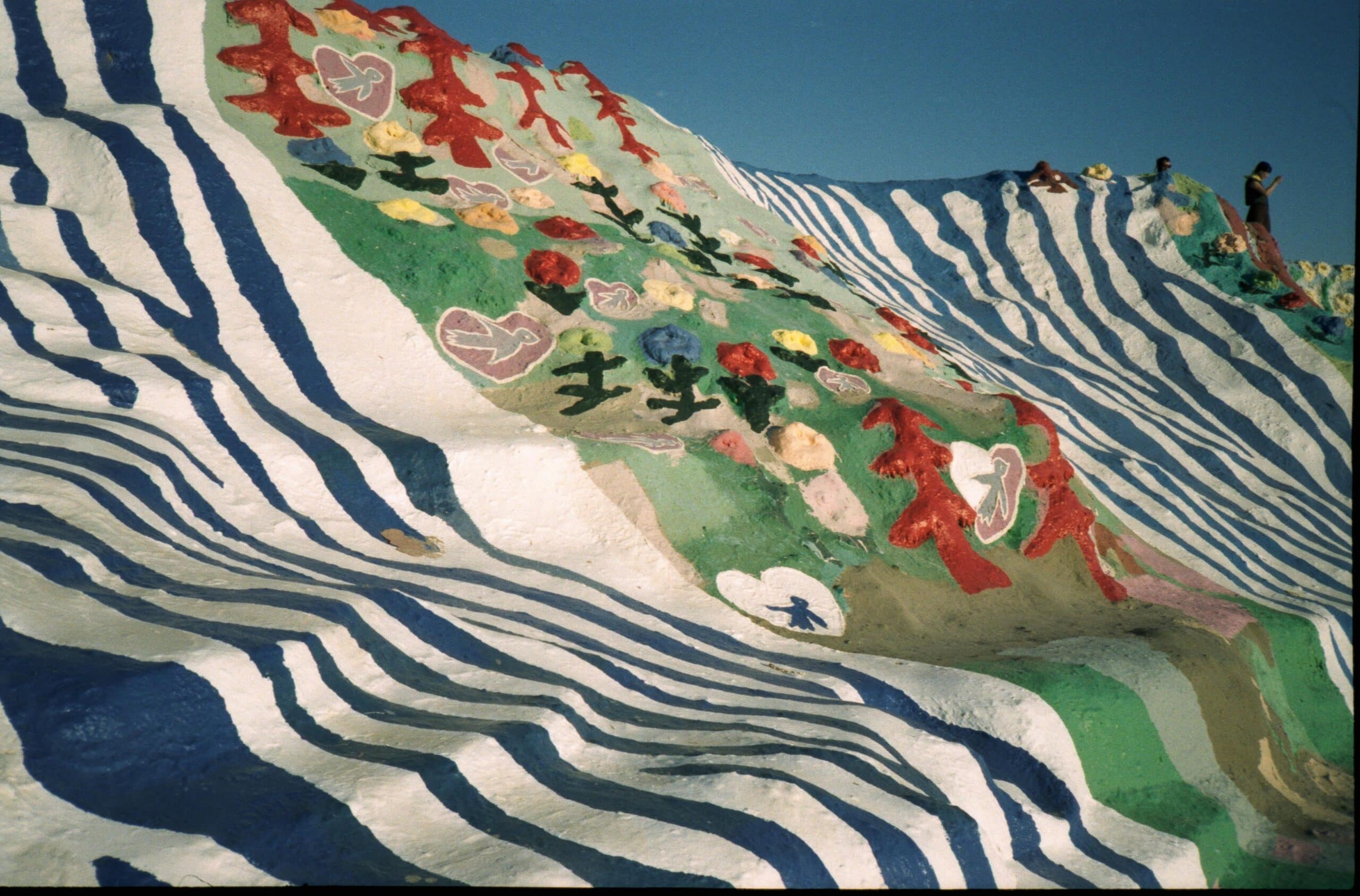 A closeup of Salvation Mountain. It is near Palm Springs, and the perfect detour on a Los Angeles to Coachella road trip.